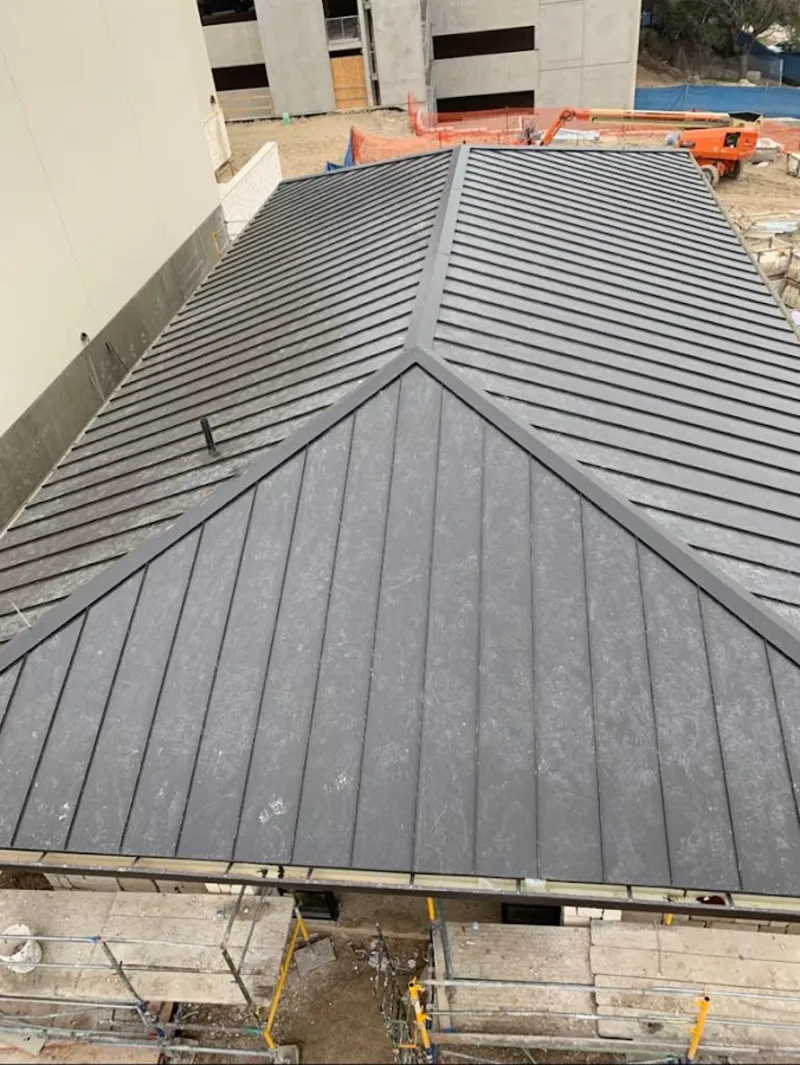 Commercial metal roof construction with crane equipment in Callaway