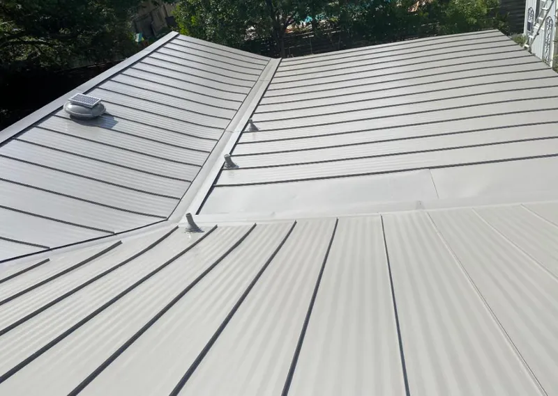 Solar attic fan installed on a metal roof for Roof Ventilation in Callaway